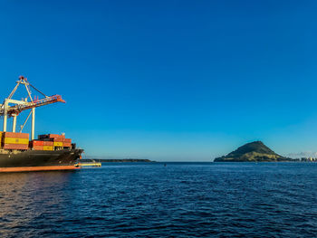 Scenic view of sea against clear blue sky