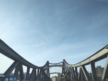 Low angle view of suspension bridge against sky