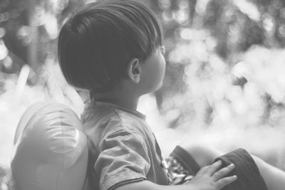 Close-up of boy sitting outdoors