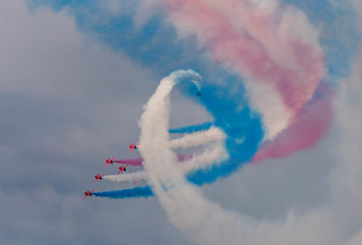 Low angle view of airshow against sky