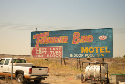 Information sign on road against clear sky