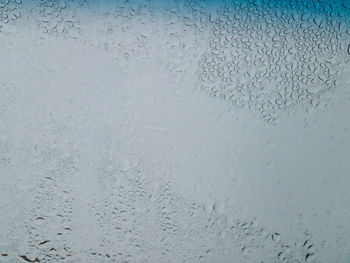 Full frame shot of raindrops on glass window