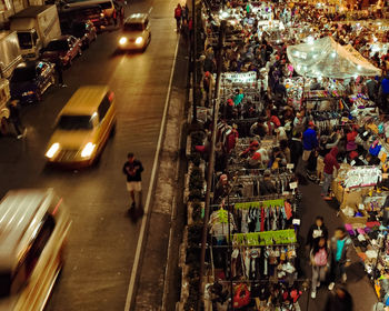 High angle view of people on city street at night