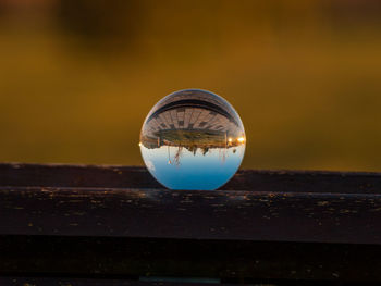 Close-up of crystal ball on wood