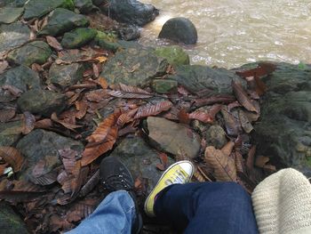 Low section of people sitting on stones