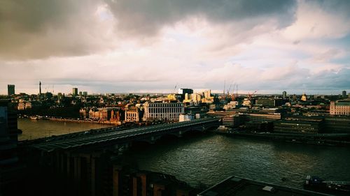 View of cityscape against cloudy sky