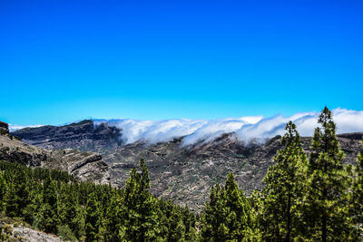 Scenic view of mountains against clear blue sky