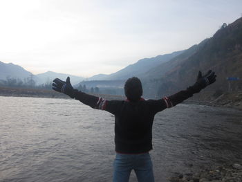 Rear view of a man on landscape against mountain range