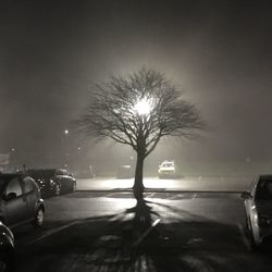 Cars on road against sky at night