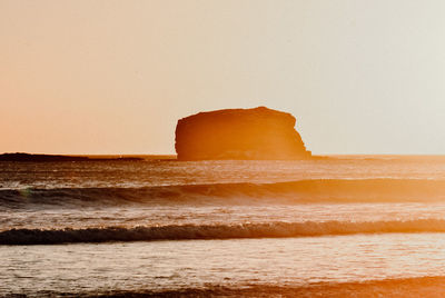 Scenic view of sea against clear sky during sunset