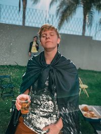 Portrait of teenage boy drinking glass