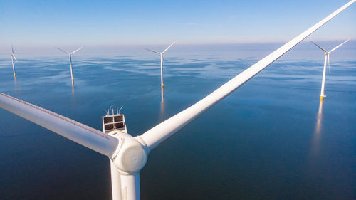 Low angle view of windmill against sky