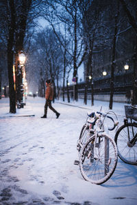 Bicycle on snow covered street in city