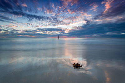 Scenic view of sea against sky at sunset