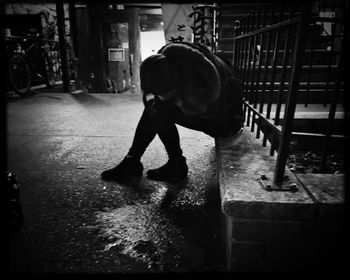 Rear view of man standing in corridor