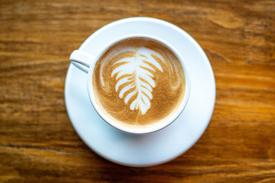 Close-up of cappuccino served on table