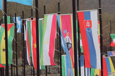 Close-up of multi colored flags hanging on wall