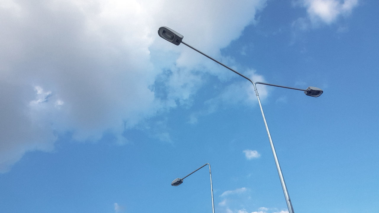 LOW ANGLE VIEW OF STREET LIGHTS AGAINST BLUE SKY