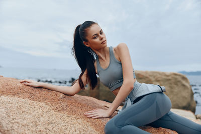 Young woman sitting on beach