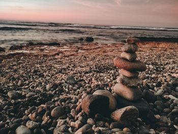 Close-up of pebbles on beach against sky