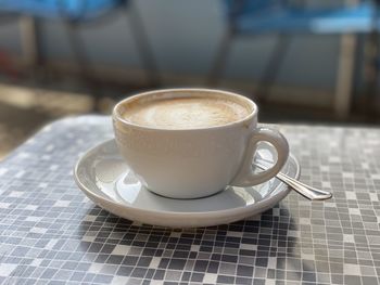 Close-up of white coffee cup on table