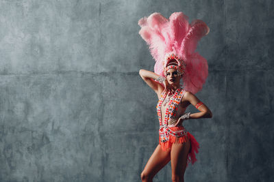 Full length of woman dancing against white background