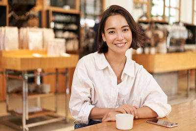 Portrait of young businesswoman working at clinic