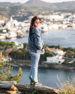 Woman standing on rock by lake