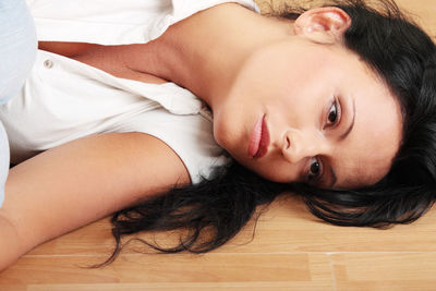 Portrait of woman lying down on bed