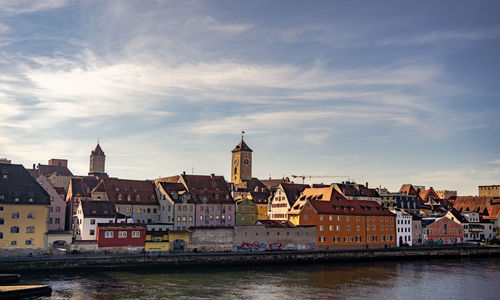 Buildings in city against cloudy sky