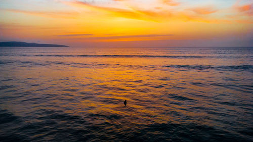 Scenic view of sea against orange sky