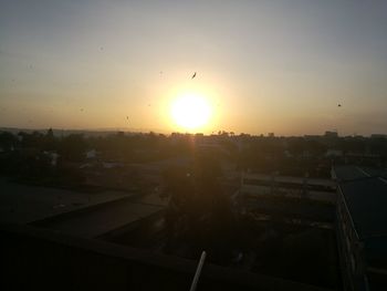 View of city against clear sky during sunset