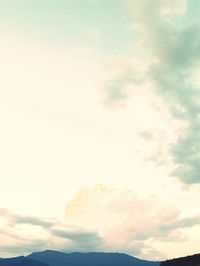 Scenic view of mountains against cloudy sky