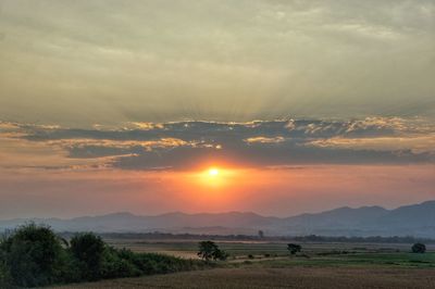 Scenic view of field against sky during sunset