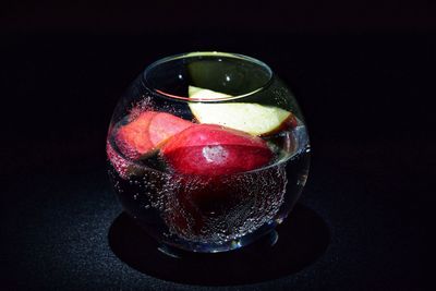 Close-up of drink served on table against black background