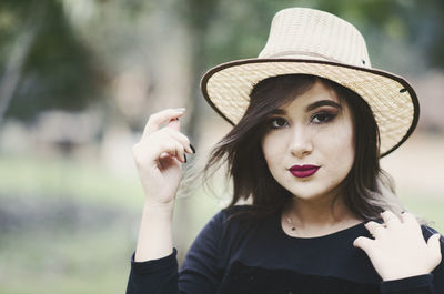 Portrait of young woman wearing hat