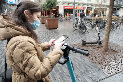 Brussels belgium - 01.31.2022 a young woman in a warm down jacket and a mask