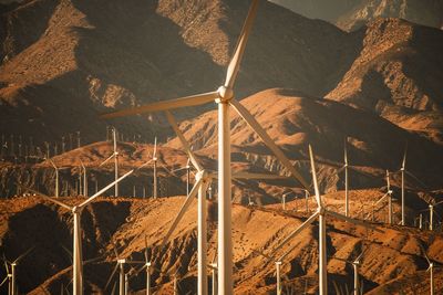 High angle view of wind turbine against mountain range