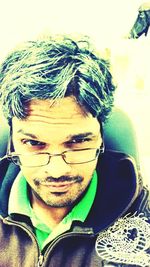 Portrait of man wearing eyeglasses at home