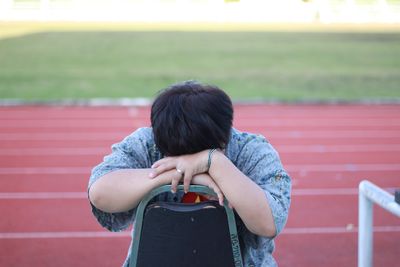 Rear view of man standing against red wall