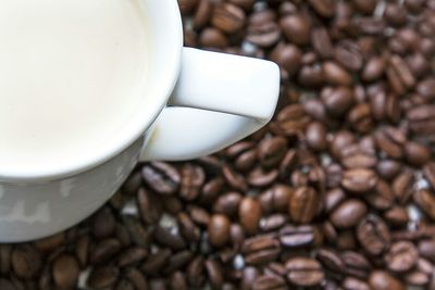 Close-up of cup on coffee beans