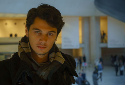 Close-up portrait of young man wearing scarf