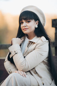 Portrait of young woman sitting outdoors