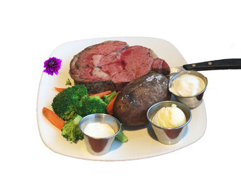Close-up of meal served in bowl against white background