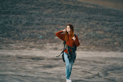 Full length of young woman walking on land