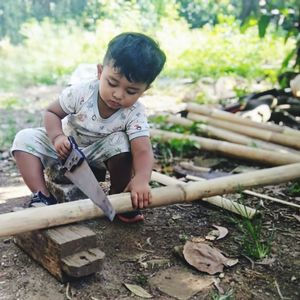 Learning to cut bamboo, he is my son