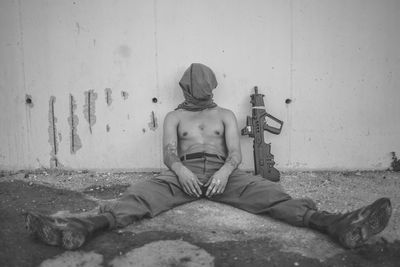 Close-up of man leaning on wall