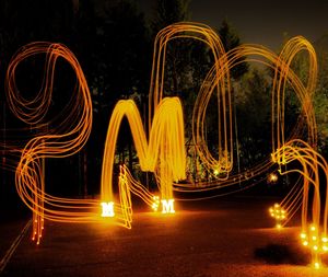 Light trails against illuminated lights at night