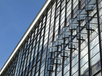 Low angle view of modern building against clear blue sky