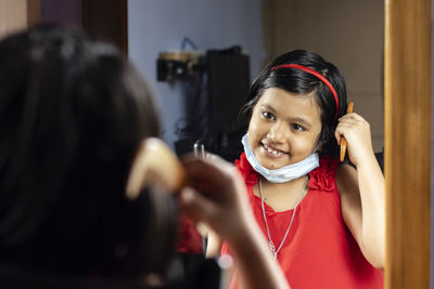 Portrait of smiling girl standing at home